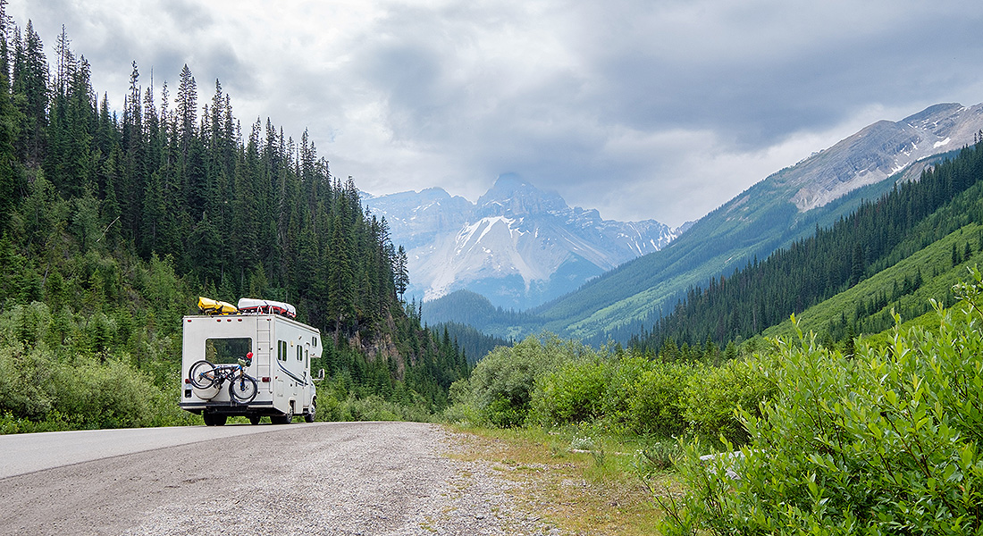 motorhome on a road trip through alpine forest