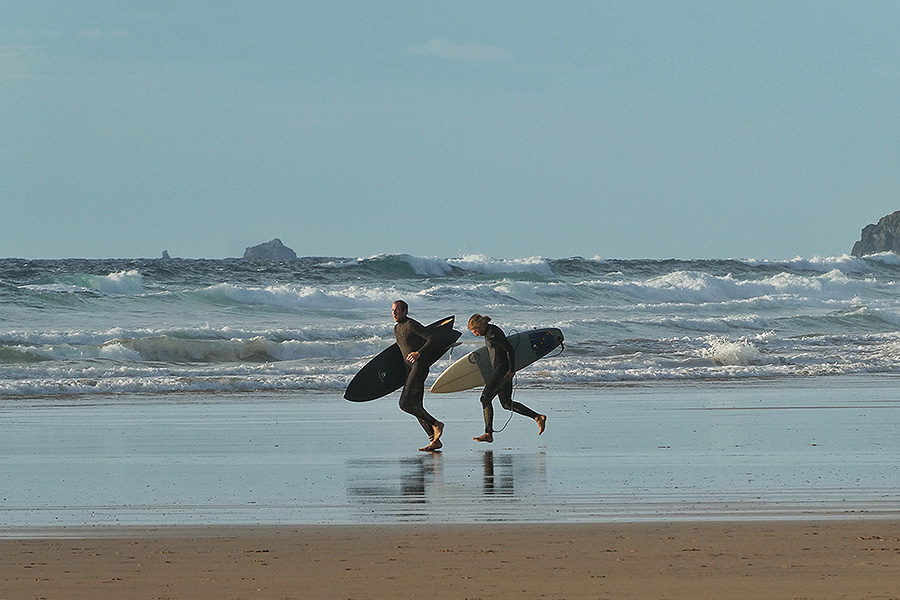 a pair of surfers at watergate bay cornwall